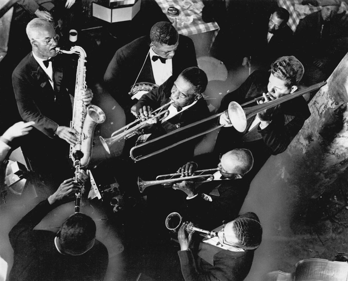 A photo of a group of people playing trombones