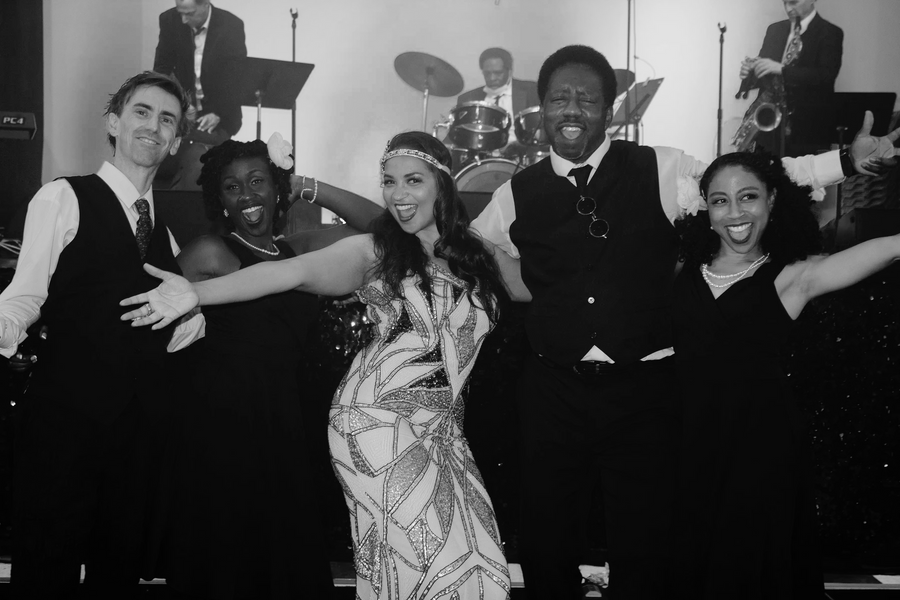 A photo of a group of people posing for the camera in jazz show
